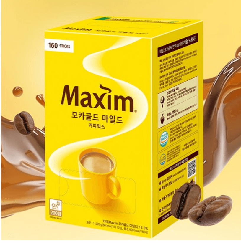 맥심 모카골드 마일드 커피믹스 (The image shows a bright yellow box of Maxim coffee mix. The box features the brand name "Maxim" prominently in brown text, along with Korean text below it. The packaging indicates that it contains 160 sticks of coffee mix. There is an image of a yellow coffee cup filled with coffee on the front. Coffee beans and splashes of coffee are also depicted around the box, adding a dynamic and appealing look. The background is a gradient of yellow shades.)